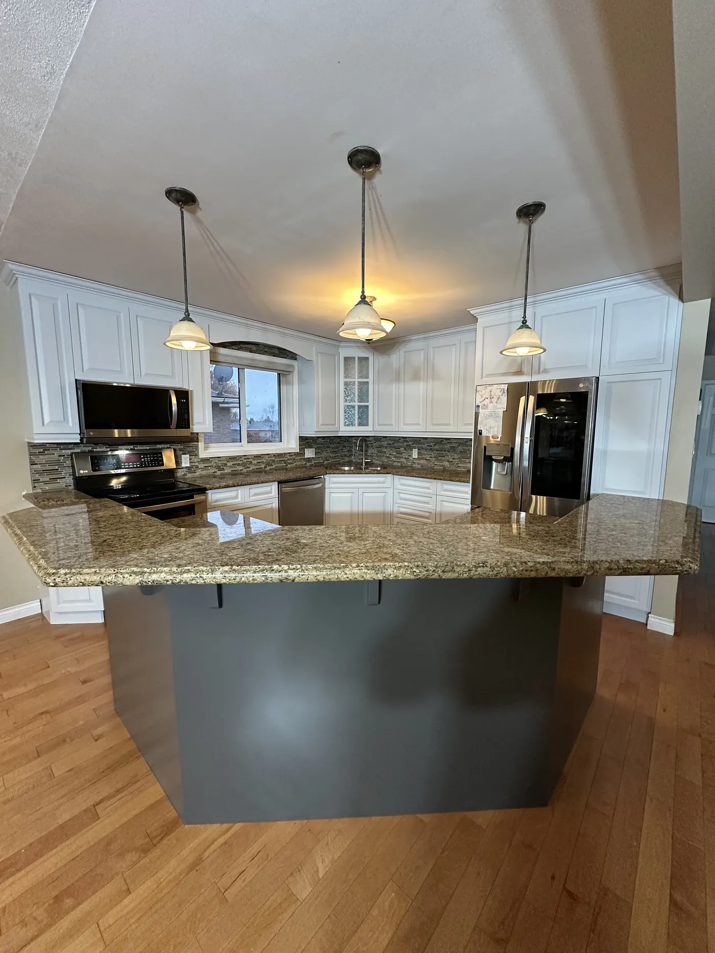 Same North Bay kitchen with white sprayed cabinets after refinishing