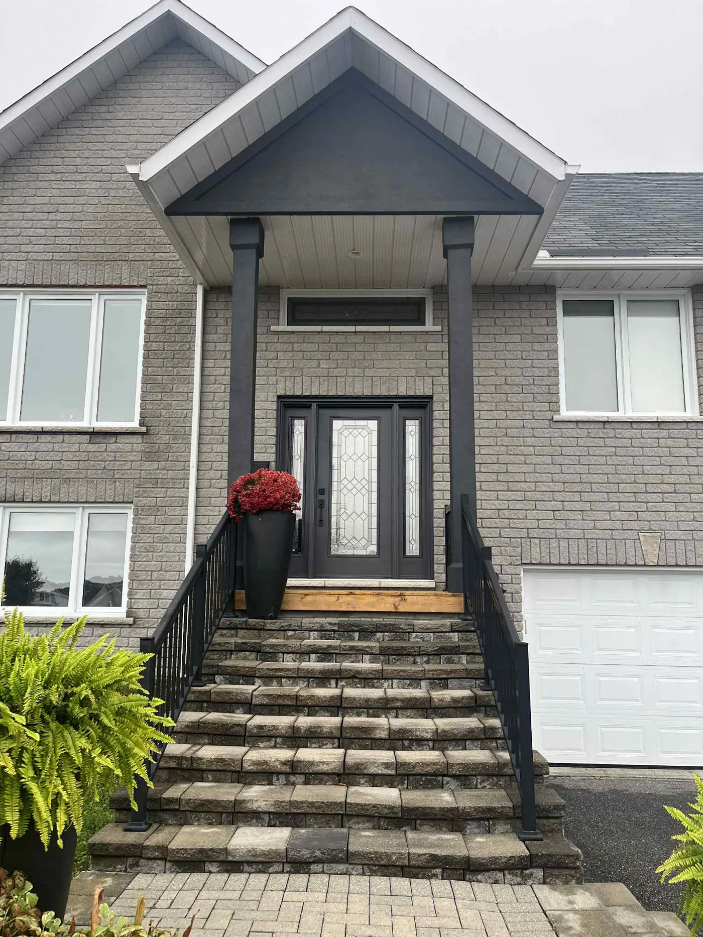 Same North Bay two-storey home after exterior repaint with refreshed siding and trim