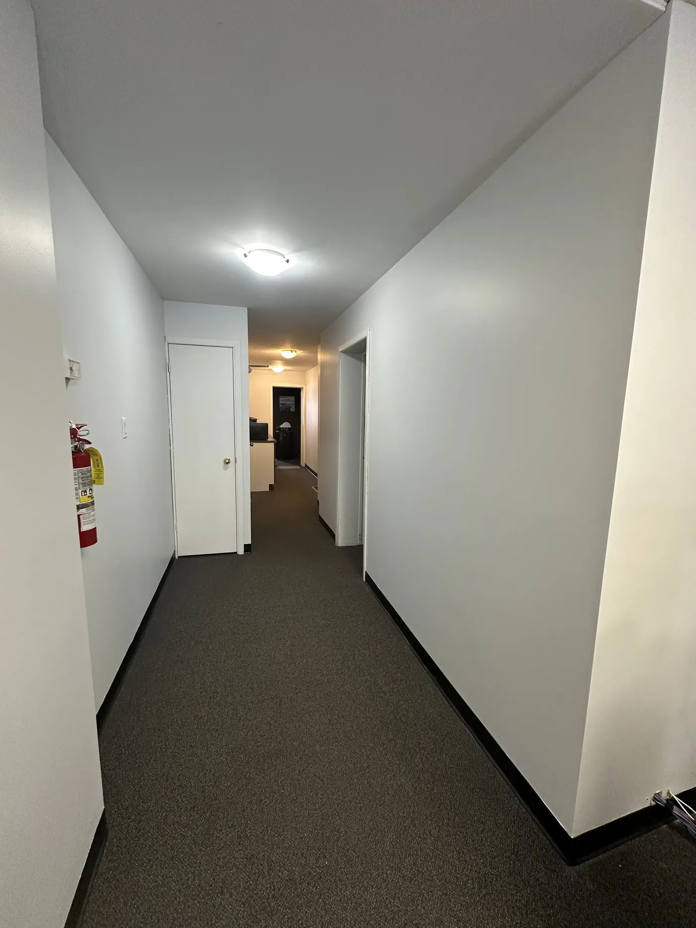 Commercial corridor with crisp white walls freshly repainted by All In One Painting