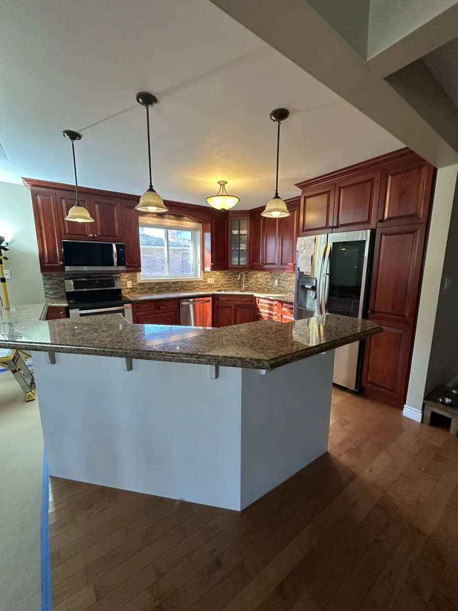 Kitchen with dark cherry cabinets before refinishing
