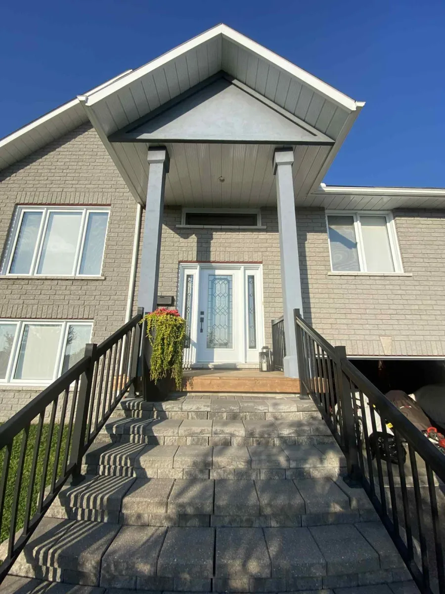 Home exterior with original light grey trim and columns